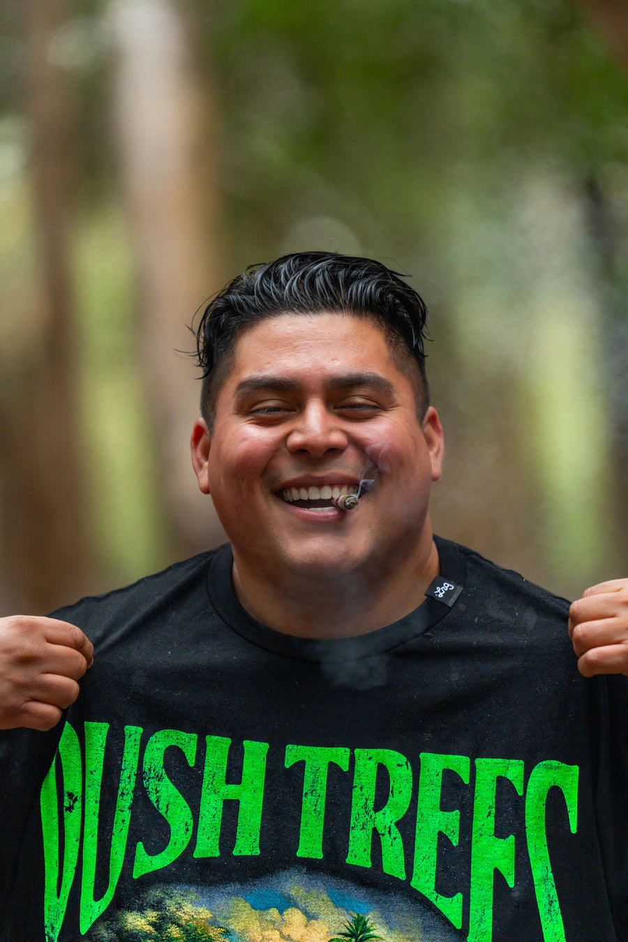 LRG customer holding a black Wish Trees graphic tee