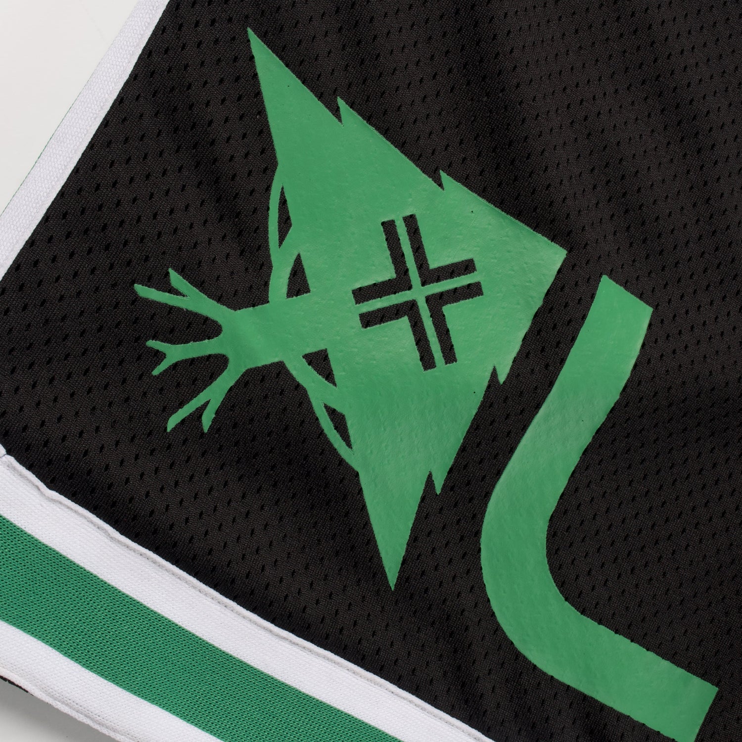 Close-up of a sports jersey with a green logo on a black background
