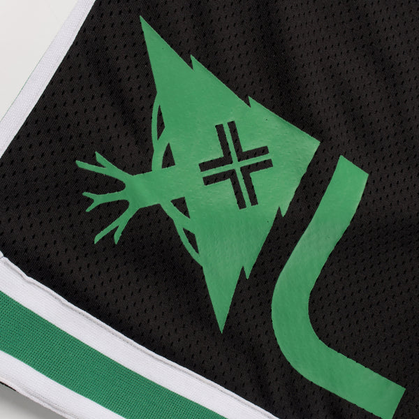 Close-up of a sports jersey with a green logo on a black background