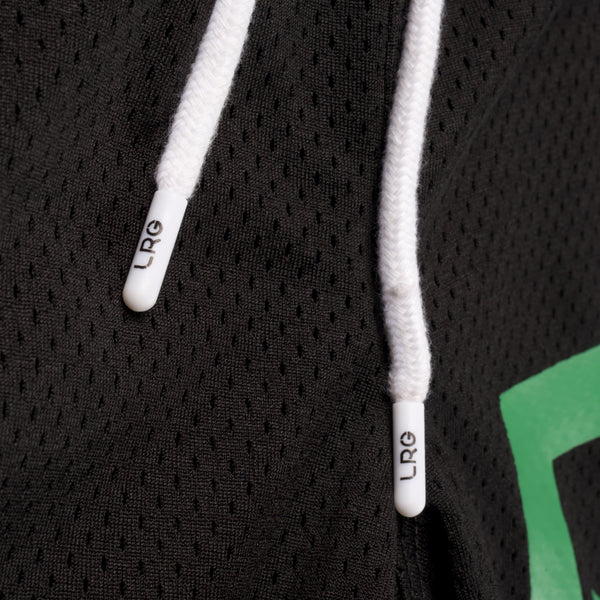 Close-up of a black hoodie with white drawstrings and green lettering.