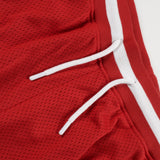 Red shorts with white drawstring on a light gray background
