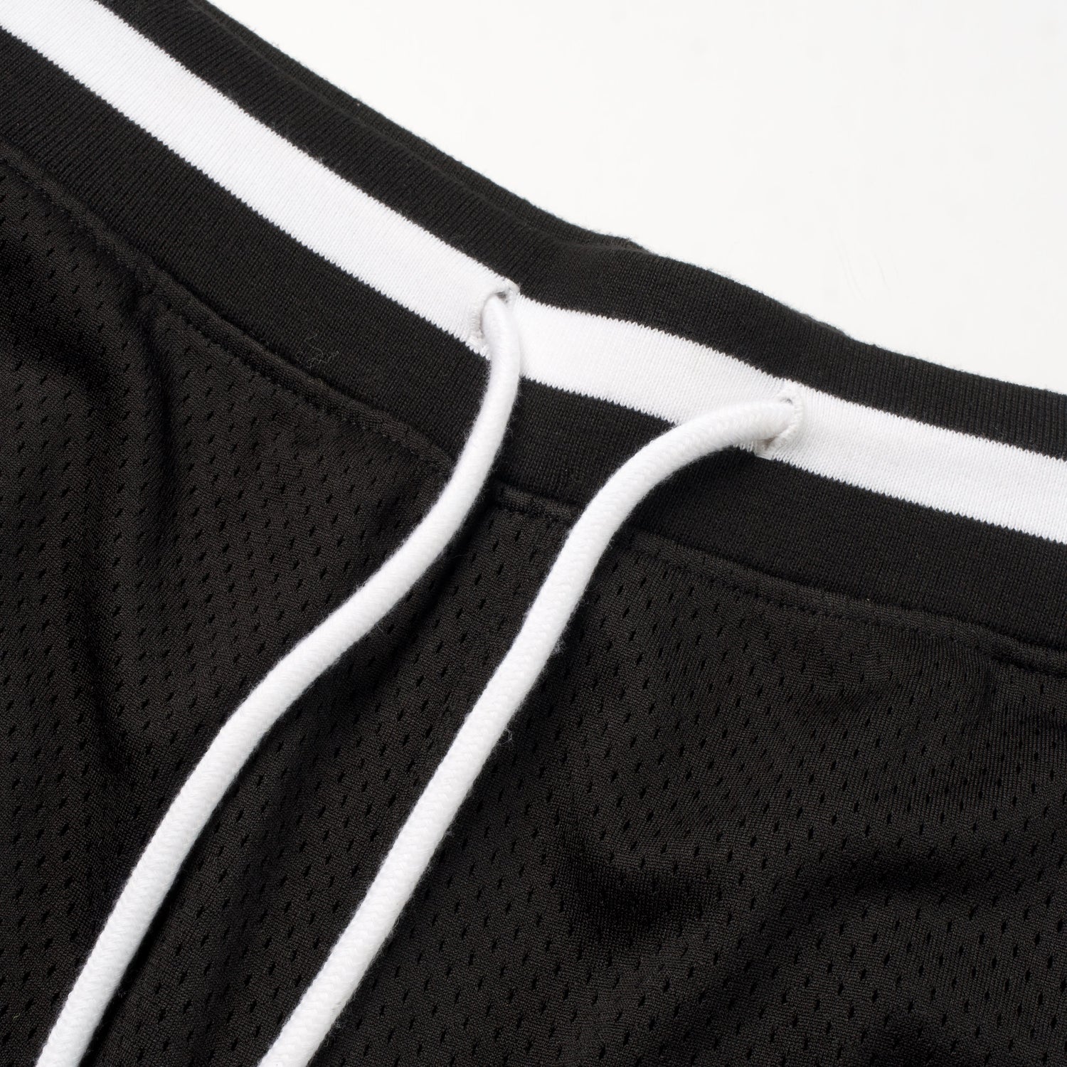 Close-up of a black and white sports jacket with mesh texture.