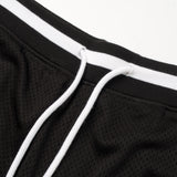 Close-up of a black and white sports jacket with mesh texture.