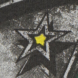 Close-up of a star design with a yellow center on a textured surface.