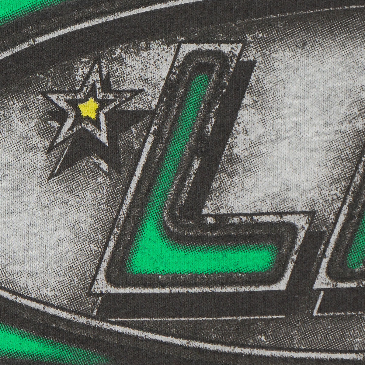 Close-up of a logo with a star and letter 'L' on a textured background