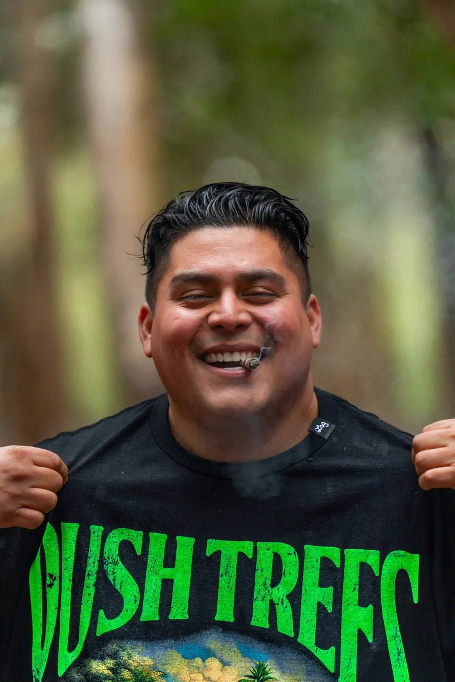 LRG customer holding a black Wish Trees graphic tee